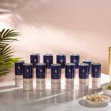 Twelve cans of Savyll alcohol-free Bellini cocktail arranged on a table with a plant and snacks nearby.