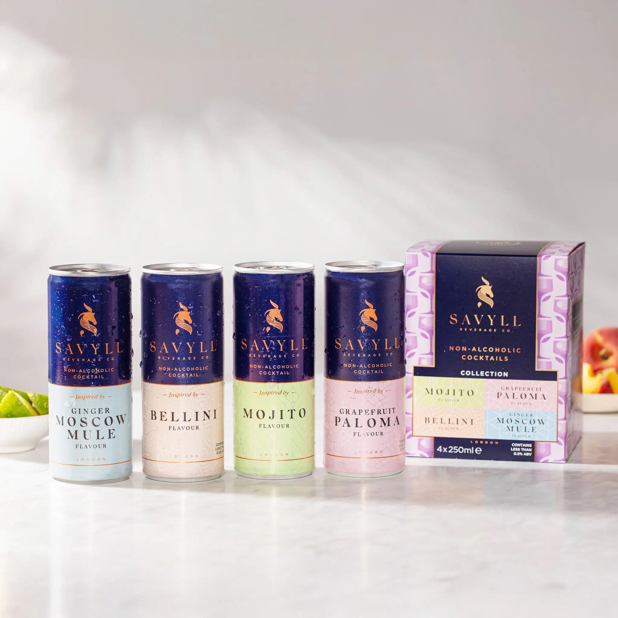 Four cans of Savyll alcohol-free cocktails in flavors Ginger Moscow Mule, Bellini, Mojito, and Grapefruit Paloma next to their mixed 4-pack 