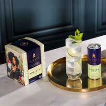 Box of Savyll non-alcoholic mojito cocktails next to a can and a glass with lime slices and mint on a gold tray.