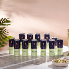 Twelve cans of Savyll non-alcoholic mojito cocktail arranged on a marble surface with snacks and a plant nearby.